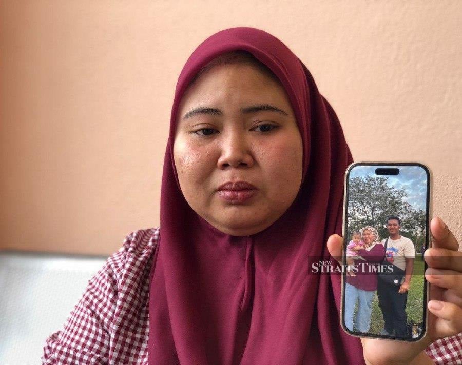 Nur Hafizah is the wife of Mohd Robbil Adam Mohd Rizal, 27, who died after the Proton Saga BLM car they were in was struck by a burning tree branch on Jalan Hutan Kampung, Kampung Bohor, here today. - NSTP/ ZULIATY ZULKIFFLI