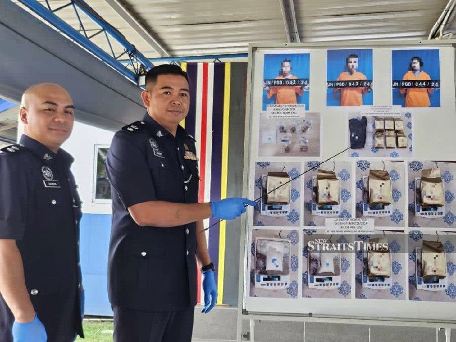  Penampang District police chief Superintendent Sammy Newton gestures during the press conference at the district police headquarters. - NSTP/Juwan Riduan 