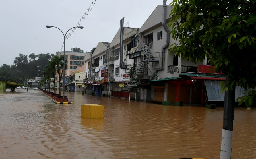 This June 28 pic shows the township of Donggongon inundated with flood waters following heavy rain. - BERNAMA