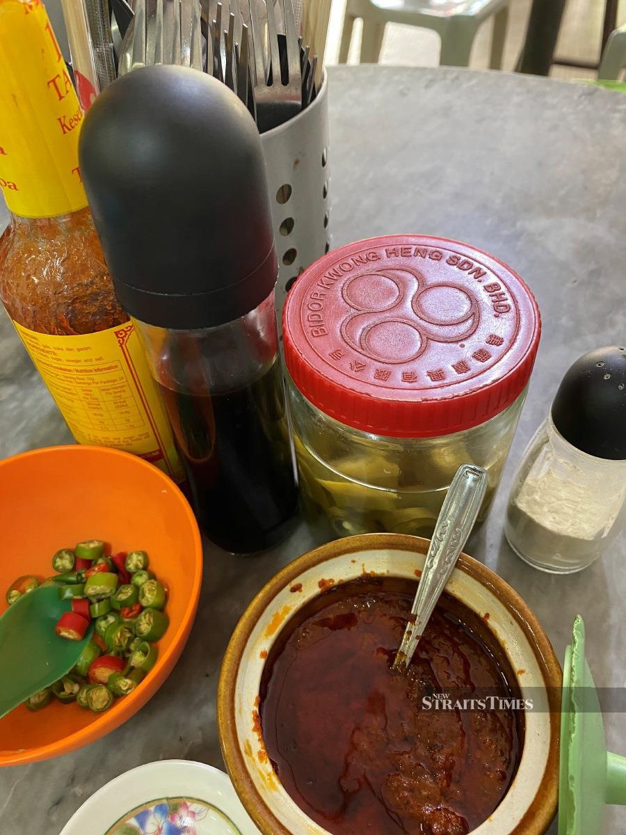 Enhance the flavours of your dishes with anyone of these condiments - (clockwise, from left) chili sauce, light soy sauce, pickled chili, white pepper powder, chili sambal and cili api.