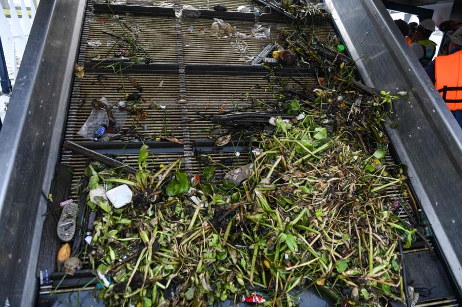 Floating plastic, trash and plants are collected onto the conveyor belt of The Ocean Cleanup's Interceptor during a press visit on the Chao Phraya river in Bangkok on March 26, 2024. -- Pic: AFP