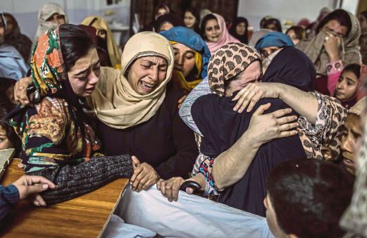 Relatives of Mohammed Ali Khan, 15, a student who was killed during an attack by Taliban gunmen on the Army Public School, at his house in Peshawar. REUTERS