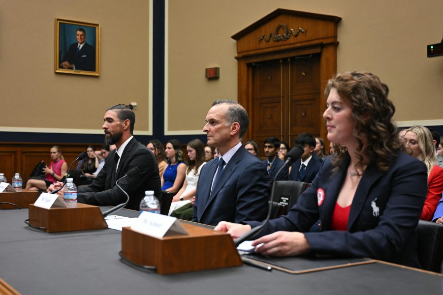 Former US Olympians Michael Phelps (L) and Allison Schmitt (R) and US Anti-Doping Agency CEO Travis Tygart testify before a House Oversight and Investigations Subcommittee hearing on anti-doping measures ahead of the 2024 Paris Olympics on Capitol Hill in Washington, DC. -- AFP