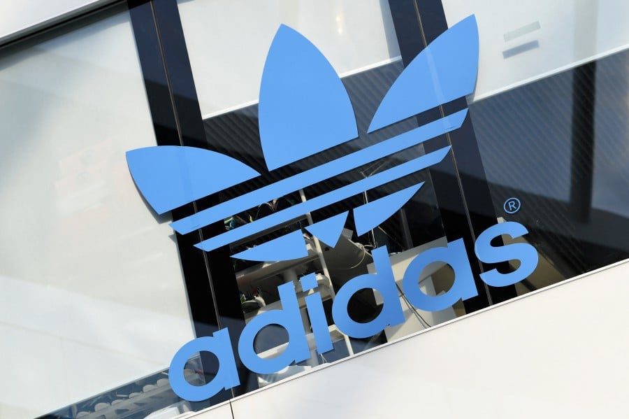 FILE PHOTO: The Adidas logo is pictured during celebrations for German sports apparel maker Adidas' 70th anniversary at the company's headquarters in Herzogenaurach, Germany, August 9, 2019. -- REUTERS Filepic