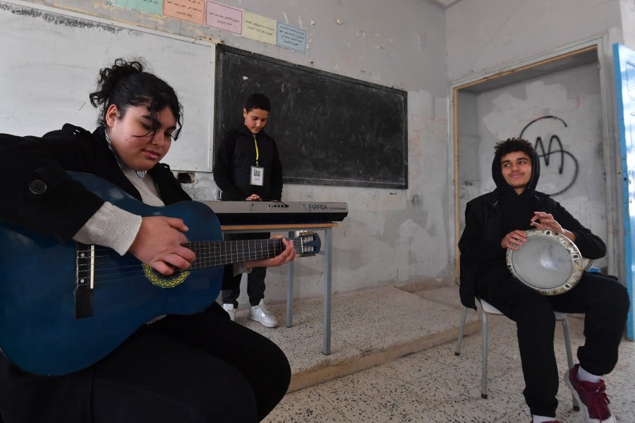 Students attend a music class financed by the after-school club Tunisia 88, at the Haffouz secondary school in Tunisia's northern Kairouan region on Feb 2, 2024. -- AFP