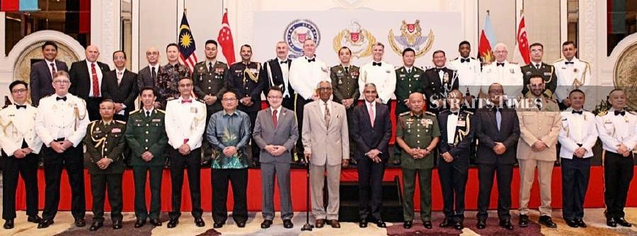 Singapore defence adviser Colonel Low Chung Guan with the guests and Military Attache Corps members at the 57th Singapore Armed Forces Day at Shangri-la Hotel in Jalan Sultan Ismail. - NSTP/ ADRIAN DAVID