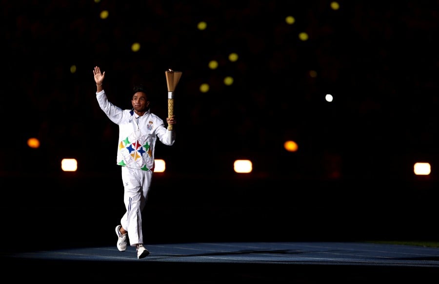Cambodian athlete and torchbearer Khim Dima during the opening ceremony. - REUTERS PIC