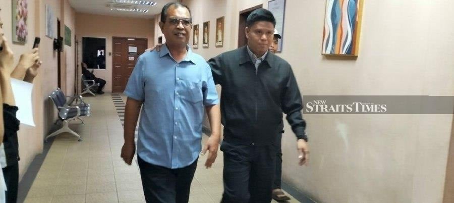 Ahmad Rudi Abd Rashid (left) was fined RM15,000 by the Special Corruption Court here today after pleading guilty to accepting bribes amounting to RM8,110 five years ago.