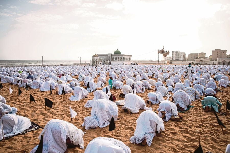 Followers of the Layene community wearing protective masks pray on the beach in front of the Yoff Layene Mosque, during the Islamic festivity of Korite in Dakar, Senegal, Korite marks the end Muslim Holy month of Ramadan. - AFP Pix