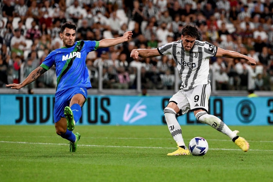 Juventus' Dusan Vlahovic, right, and Sassuolo's Kaan Ayhan battle for the ball during the Italian serie A soccer match between Juventus and Sassuolo at the Juventus Stadium, Turin. - AP PIC