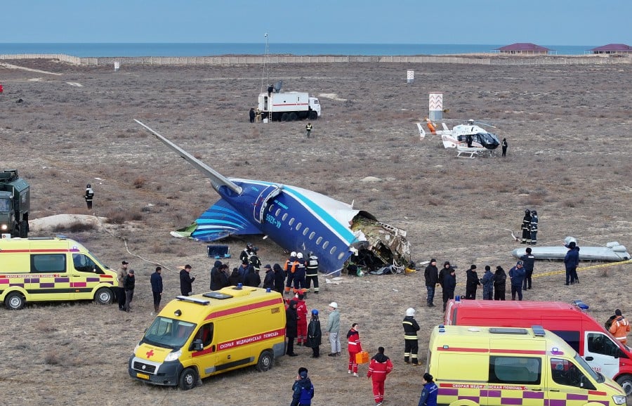 A drone view shows emergency specialists working at the crash site of an Azerbaijan Airlines passenger plane near the city of Aktau, Kazakhstan on Dec 25. -- REUTERS/File Photo