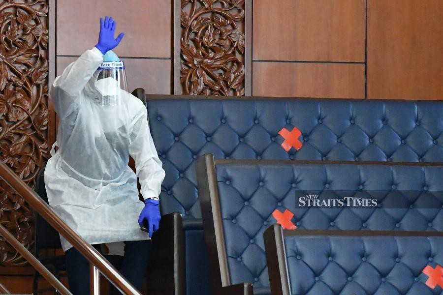 This Dec 15 picture shows Human Resources Minister Datuk Seri M. Saravanan wearing a full personal protective equipment, during the the Dewan Rakyat sitting. 