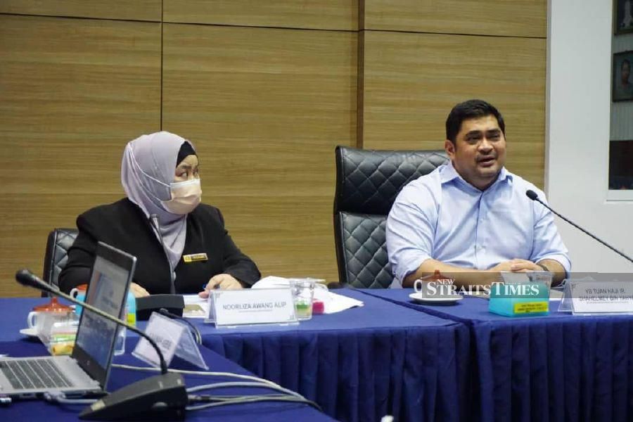 Sabah Community Development and People's Wellbeing Minister Shahelmy Yahya(right) listening to a briefing by City mayorNoorliza Awang Alip. - Photo courtesy of Shahelmy Yahya. 