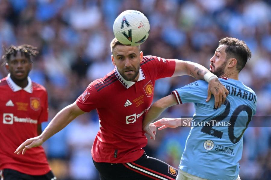 Manchester United's Luke Shaw (centre) vies with Manchester City's Bernardo Silva (right) during the FA Cup final at Wembley Stadium, London, on June 3, 2023. AFP PIC