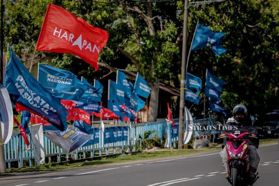 A road along Tanjong Kling is covered with flags of political parties ahead of the Melaka State Election. - NSTP/ASYRAF HAMZAH 