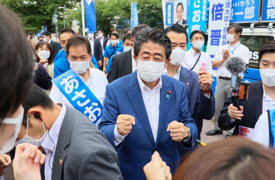 This picture taken on July 6, 2022 shows former Japanese Prime Minister Shinzo Abe (C) meeting with supporters after he delivered a campaign speech for the ruling Liberal Democratic Party (LDP) candidate Keiichiro Asao for the Upper House election in Yokohama, suburban Tokyo. - AFP PIC