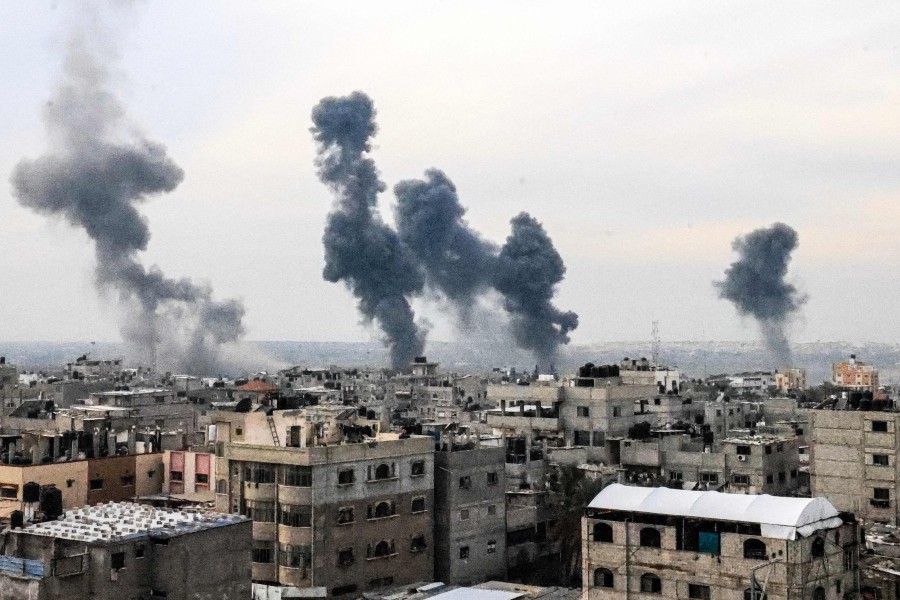 A picture taken on December 20, 2023, from Rafah shows smoke billowing after Israeli strikes over the Nuseirat refugee camp in the central Gaza Strip. - AFP PIC