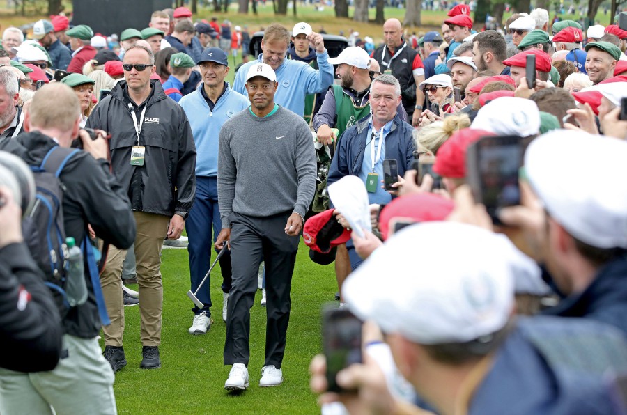 US golfer Tiger Woods walks through the crowd on the second day of the JP McManus Pro-Am golf tournament at the The Golf Course at Adare Manor in Limerick, south-west Ireland. - AFP PIC