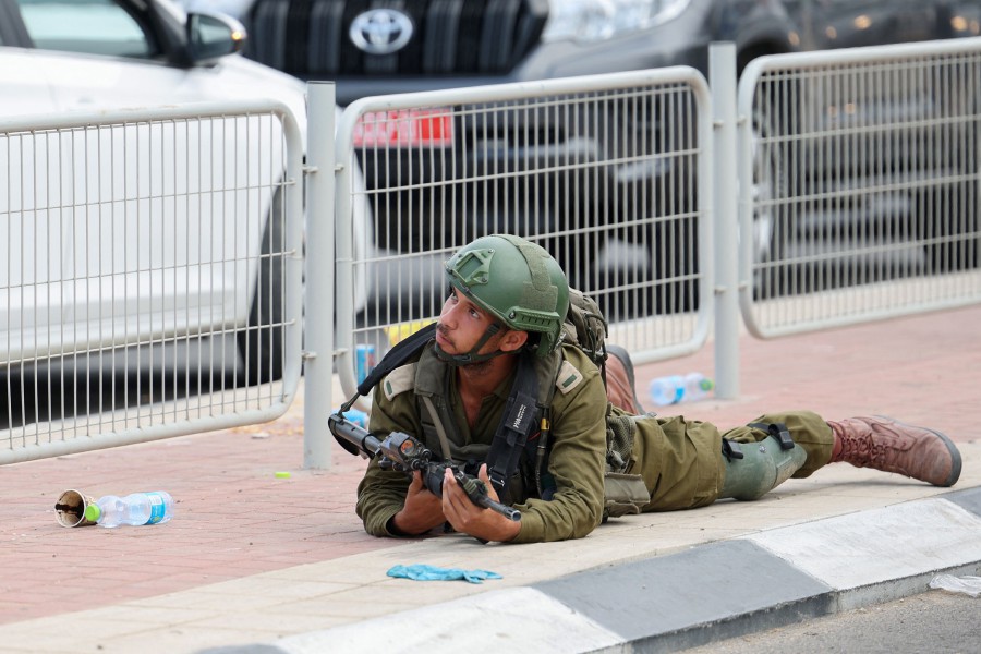  An Israeli soldier ducks for cover near Sderot on October 9, 2023, during a rocket attack from the Gaza Strip. -AFP PIC