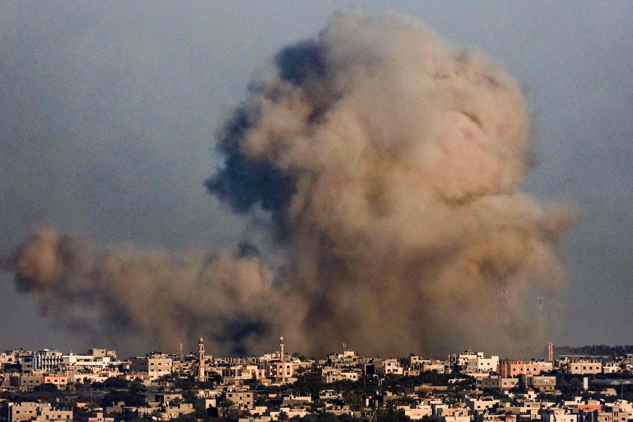 A smoke plume erupts over Khan Yunis from Rafah in the southern Gaza strip during Israeli bombardment. - AFP PIC