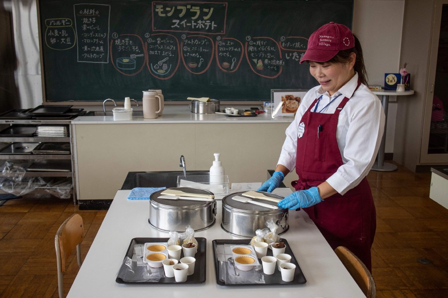 An employee preparing sweet potato desserts at a workshop at the Namegata Farmers Village, a small agricultural theme park in Ibaraki Prefecture which uses a former elementary school building. - AFP PIC