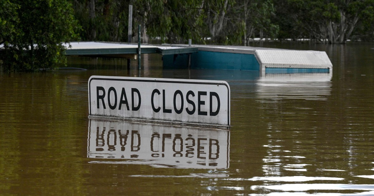 Protesters rally as Australian PM tours flood disaster