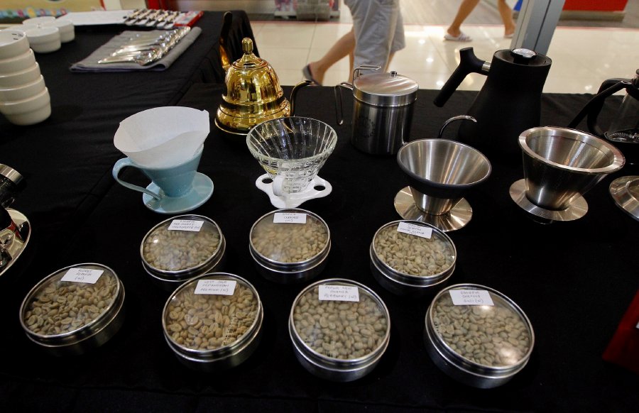 Various beans from around the world on display, together with an assortment of filtering apparutus.