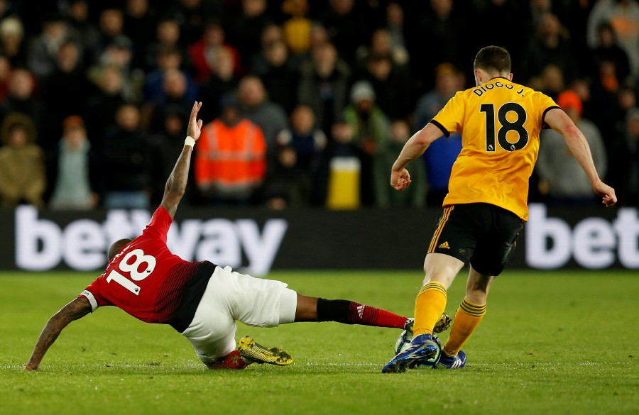  Manchester United's Ashley Young is sent off after this challenge on Wolverhampton Wanderers' Diogo Jota. - Reuters