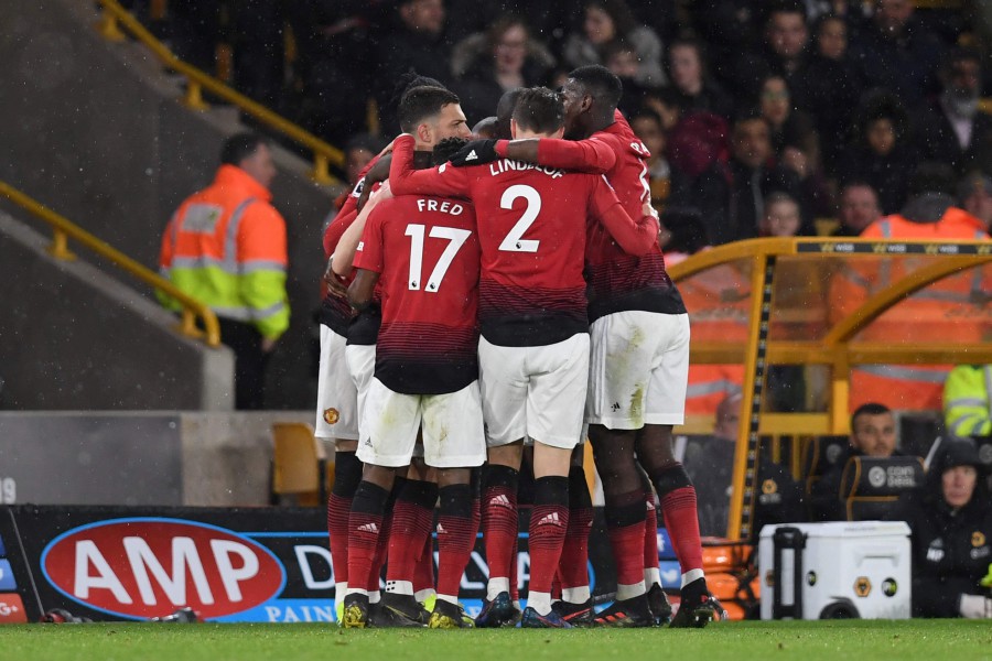Manchester United players celebrate the opening goal against Wolverhampton Wanderers. - AFP