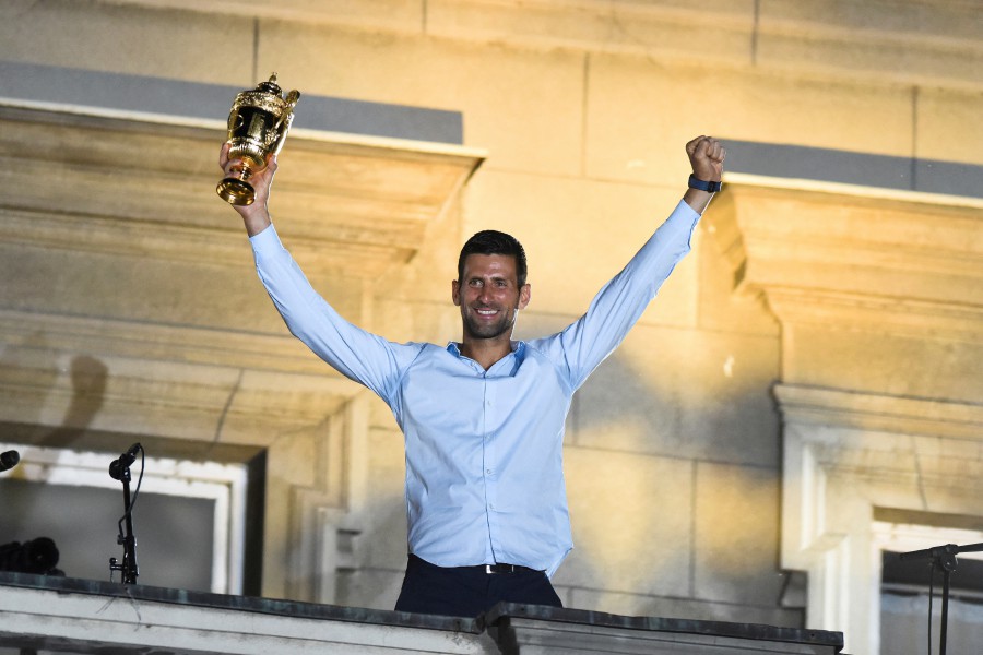 Serbian tennis player Novak Djokovic holds up the winner's trophy during a welcoming ceremony in front of the city hall in Belgrade, in Serbia. - REUTERS PIC