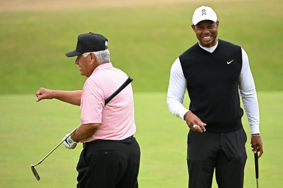 Winner of The Open in 2000, 2005 and 2006, US golfer Tiger Woods (R) and Winner of The Open in 1971 and 1972, US former golfer Lee Trevino (L) on the 18th green during The R&A Celebration of Champions, part of the build-up towards The 150th British Open Golf Championship on The Old Course at St Andrews in Scotland. - AFP PIC