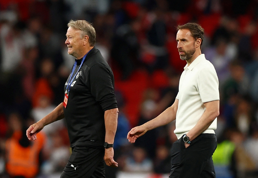 Iceland coach Age Hareide (left) celebrates as England manager Gareth Southgate looks dejected after Friday’s International Friendly at Wembley Stadium in London. - REUTERS PIC