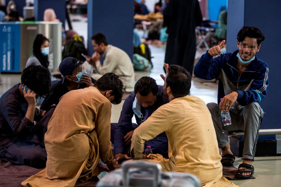 Afghan refugees waiting to be sorted into different residences at Rome Leonardo Da Vinci Airport in Fiumicino, Italy. - EPA PIC
