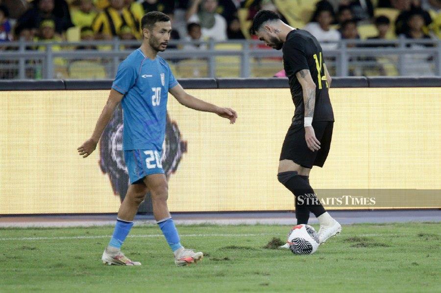 Harimau Malaya and India’s player walk on the zeon zoysia grass during the match at the Bukit Jalil National Stadium. - NSTP/AIZUDDIN SAAD