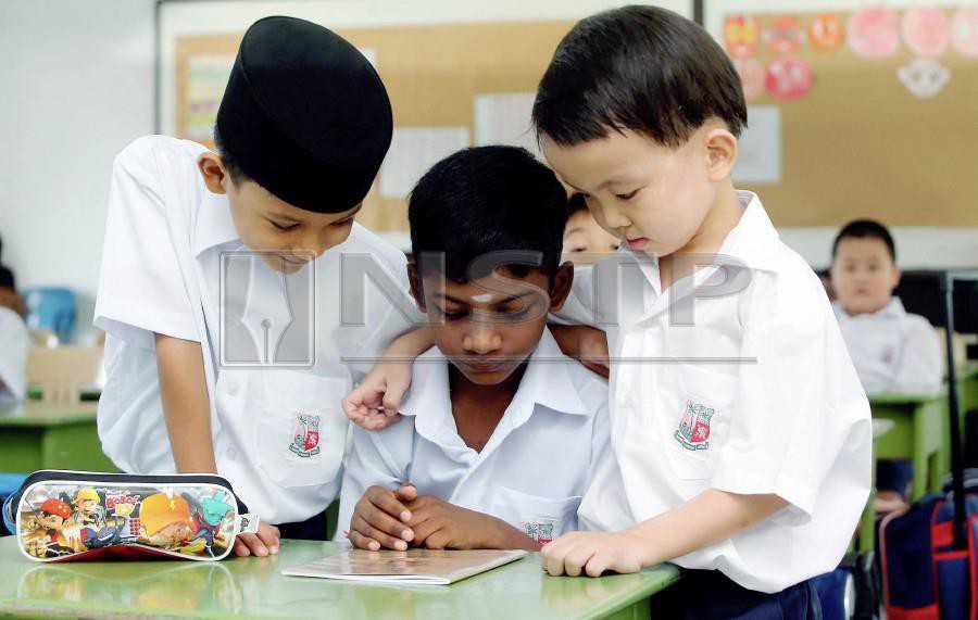 In this file pic dated Oct 20, 2016 shows year one student (from left) Shayazwan Nizamuddin, Tharenraj Rajan and Venezio Tan attending their first day at Sekolah Kebangsaan St Xavier, Air Itam.- NSTP/File pic