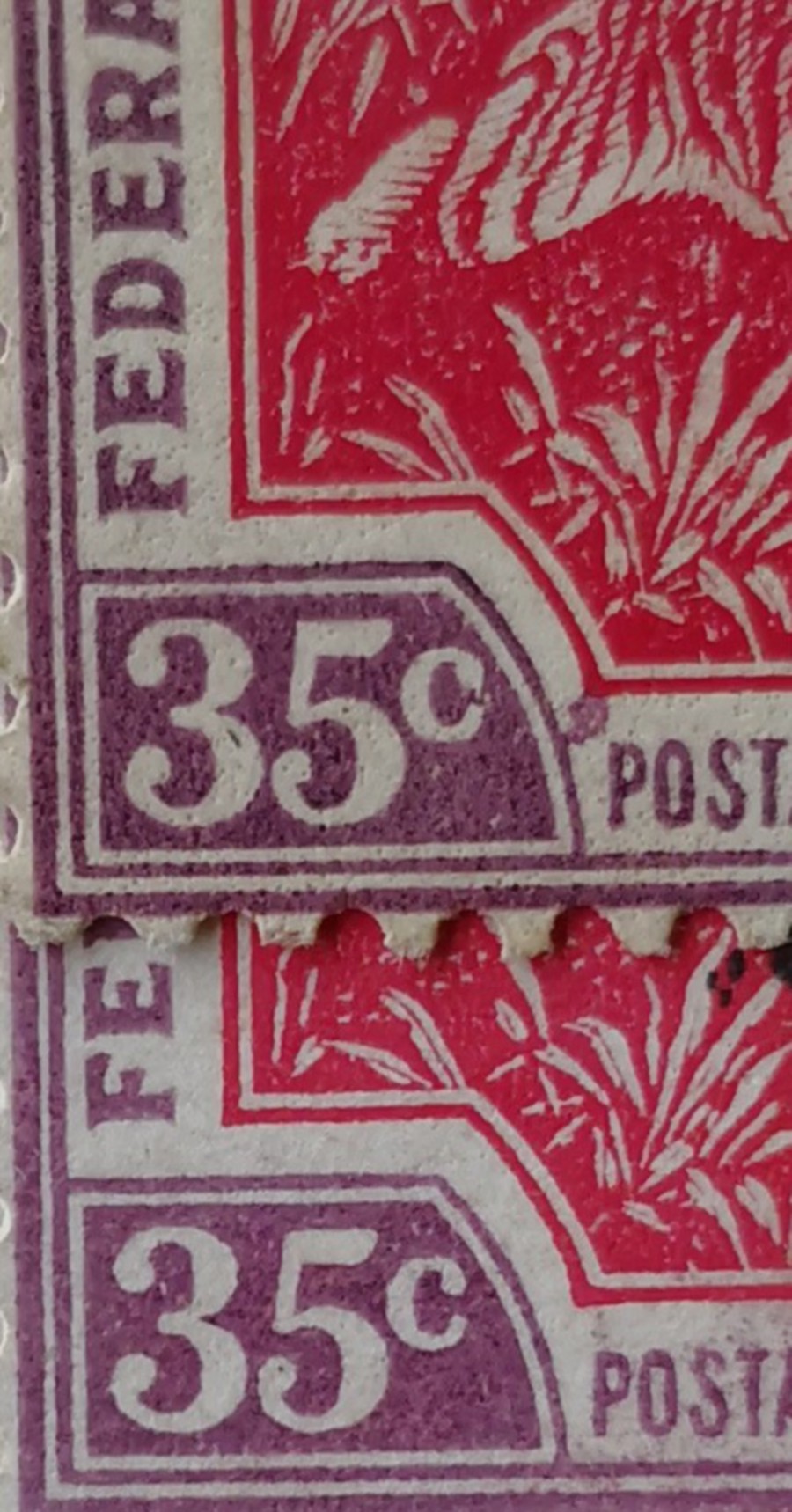 The misprinted stamp on top bears a purple smudge near the letter P while the normal stamp at the bottom doesn’t.