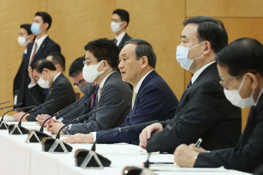 Japan's Prime Minister Yoshihide Suga (C) speaks at a cabinet meeting at the prime minister's office in Tokyo. - AFP pic
