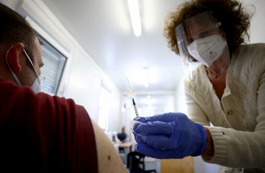 A doctor vaccinates a person with a dose of the Pfizer-BioNTech Covid-19 vaccine in Vienna, Austria on April 26, 2021. - REUTERS FILE PIC