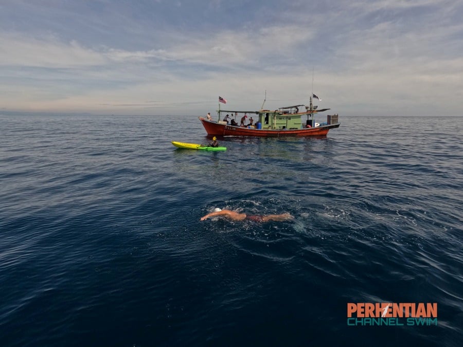 Ridzwan, who made the swim in 20 hours, 42 minutes and 26 seconds, was accompanied by his crew consisting of two escort boats and a kayak as he entered the water at the Redang Island Marine Park Centre at 9.15pm on June 24 and walked onto Pantai Bari at 5.57pm the next day. - Pic credit Facebook/Perhentian Channel Swim