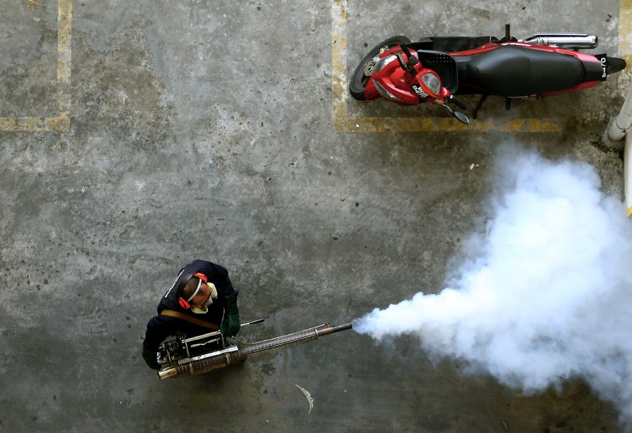 This file pic dated February 15, 2017, shows an employee of MPSJ conducting fogging at an apartment in Puchong. - NSTP file pic