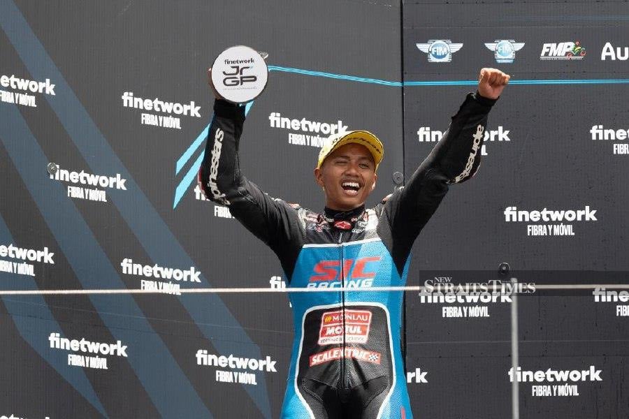  Syarifuddin Azman celebrates on the podium at the FIM JuniorGP World Championship in Portugal on Sunday. 