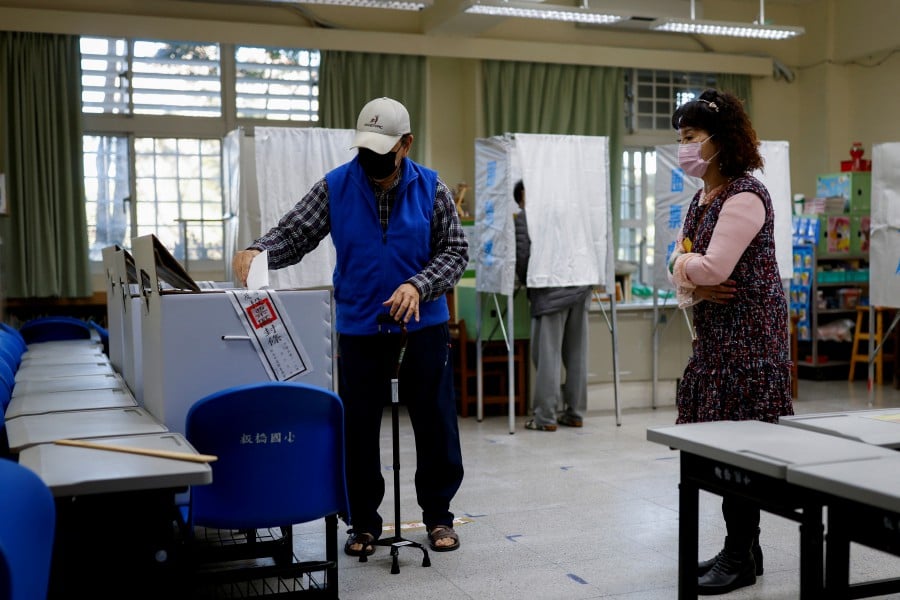 A man casts his vote at a polling station during the presidential and parliamentary elections in New Taipei City, Taiwan. (REUTERS/Carlos Garcia Rawlins)