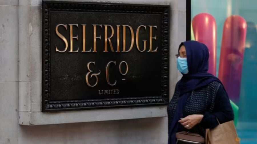 A woman wearing a face mask walks past the Selfridges Oxford street store prior to the company's temporary closure of its UK branches, as the spread of the coronavirus disease (COVID-19) continues, in London, Britain, March 18, 2020. REUTERS/Peter Nicholls/File Photo