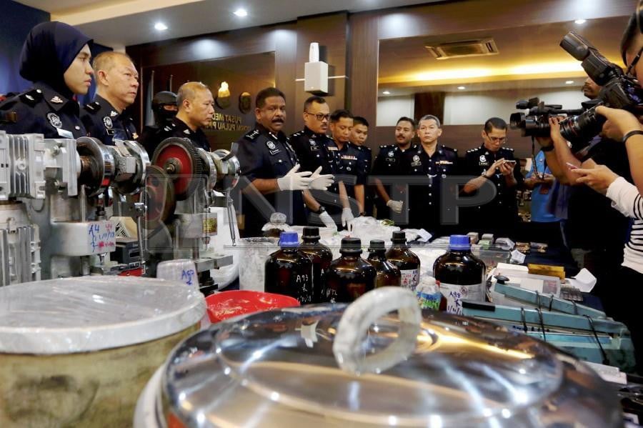 Penang police chief Datuk Seri A Thaiveegan shows some of the equipment and drugs seized, during a press conference at the Penang police headquarters. Pix by NSTP/Mikail Ong