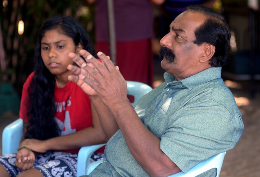 A. Suppiah, and his daughter S. Thulaasi speak to reporters when met in Penang. - Bernama
