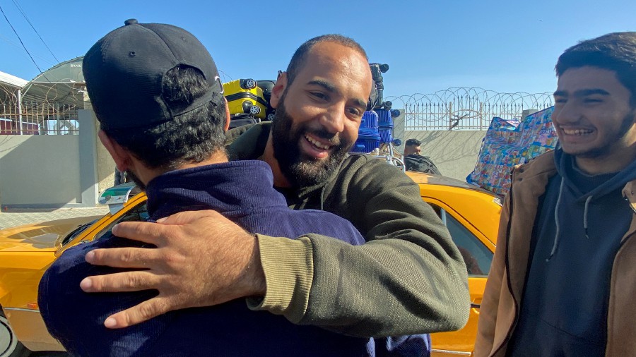 A Palestinian man, who was stranded in Egypt due to Israel-Hamas conflict, is welcomed upon his arrival during a temporary truce between Hamas and Israel, at Rafah border crossing, in the southern Gaza Strip. - REUTERS PIC