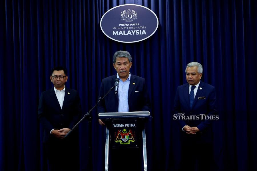 Foreign Minister Datuk Seri Mohamad Hasan (centre) speaks to reporters at the ministry’s headquarters. Also present are his deputy Datuk Mohamad Alamin (left) and the ministry’s sec-gen Datuk Seri Amran Mohamed Zin. - BERNAMA PIC