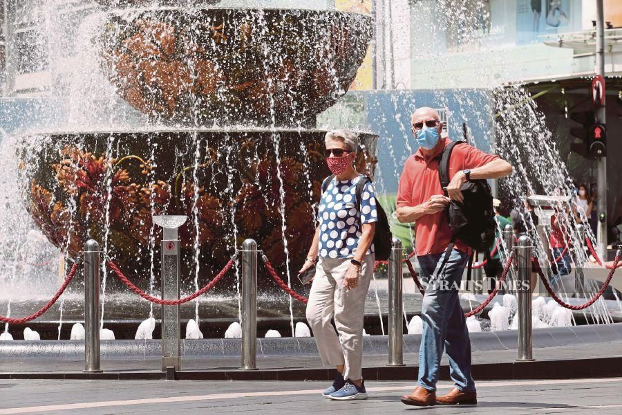 This Aug 20 file pic shows tourist walking in Kuala Lumpur, while wearing face mask amid the Covid-19 pandemic. - NSTP/EIZAIRI SHAMSUDIN