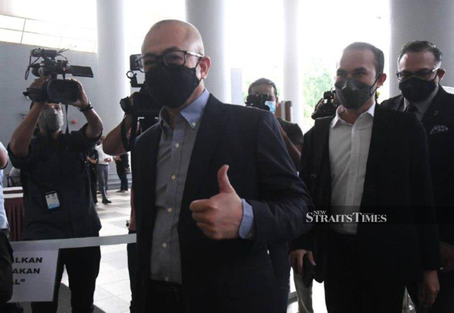 Datuk Rozman Isli gestures as he arrives at the Kuala Lumpur Session’s Court, ahead of the trial. - NSTP/MOHAMAD SHAHRIL BADRI SAALI