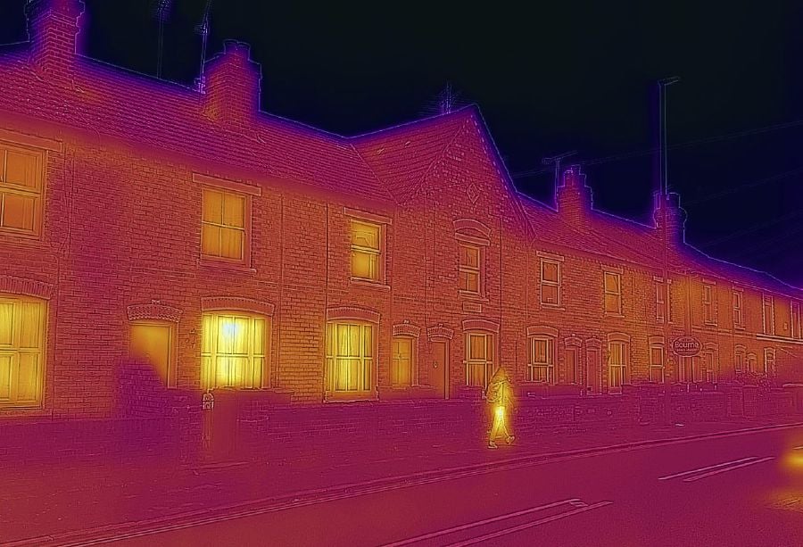 A row of terraced houses, taken with a heat-sensing camera showing higher amounts of heat emitted in the brighter parts, in Guildford, U.K., on Monday, Dec. 6, 2021. U.K. households, already bracing for their energy bills to rise by “several hundred pounds,” will see a further jump following the collapse of Bulb Energy Ltd. and other suppliers, the regulator said. Photographer: Jason Alden/Bloomberg
